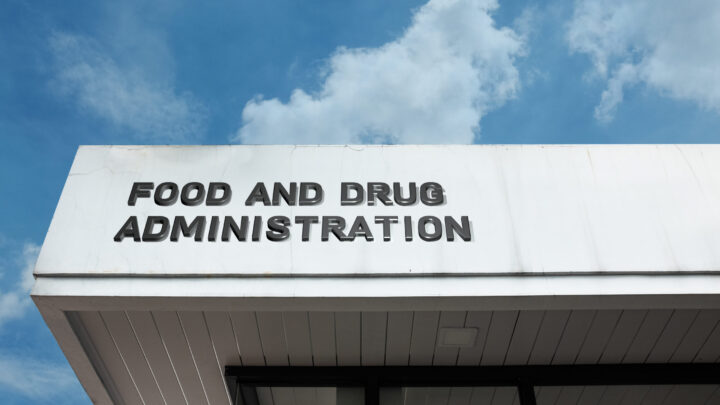 Food and Drug Administration sign displayed on a building against a clear blue sky, symbolizing government regulation, public health, consumer safety, and official standards