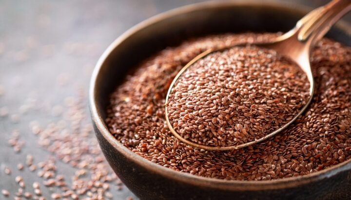 Ground flaxseed with spoon for healthy eating and dietary fiber nutrition boost